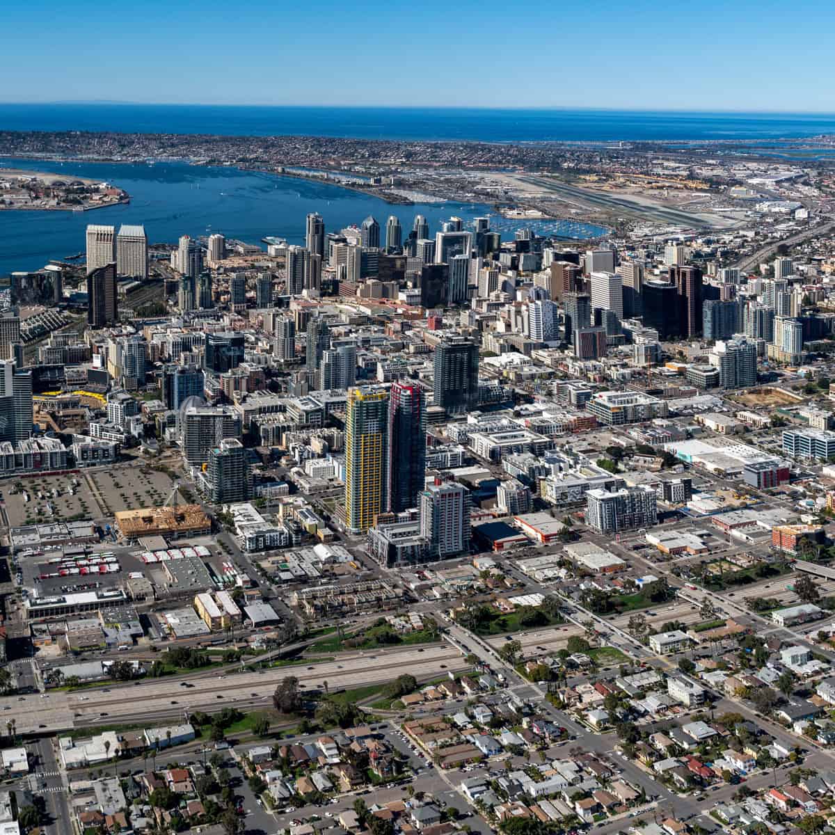 Aerial view of San Diego's downtown area featuring skyscrapers and waterfront scenery.